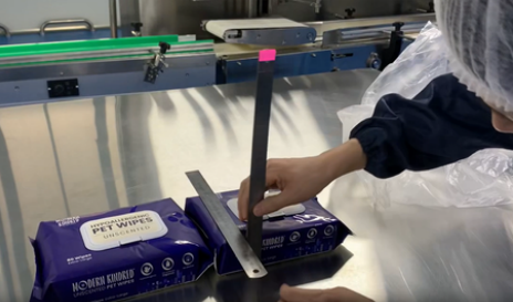 Modern Kindred Pet Wipes quality control testing on production line, ensuring consistent size and thickness
